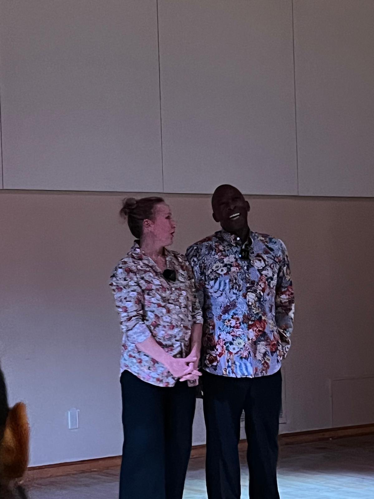 Keira Hart and Boris Willis standing side by side in matching floral shirts