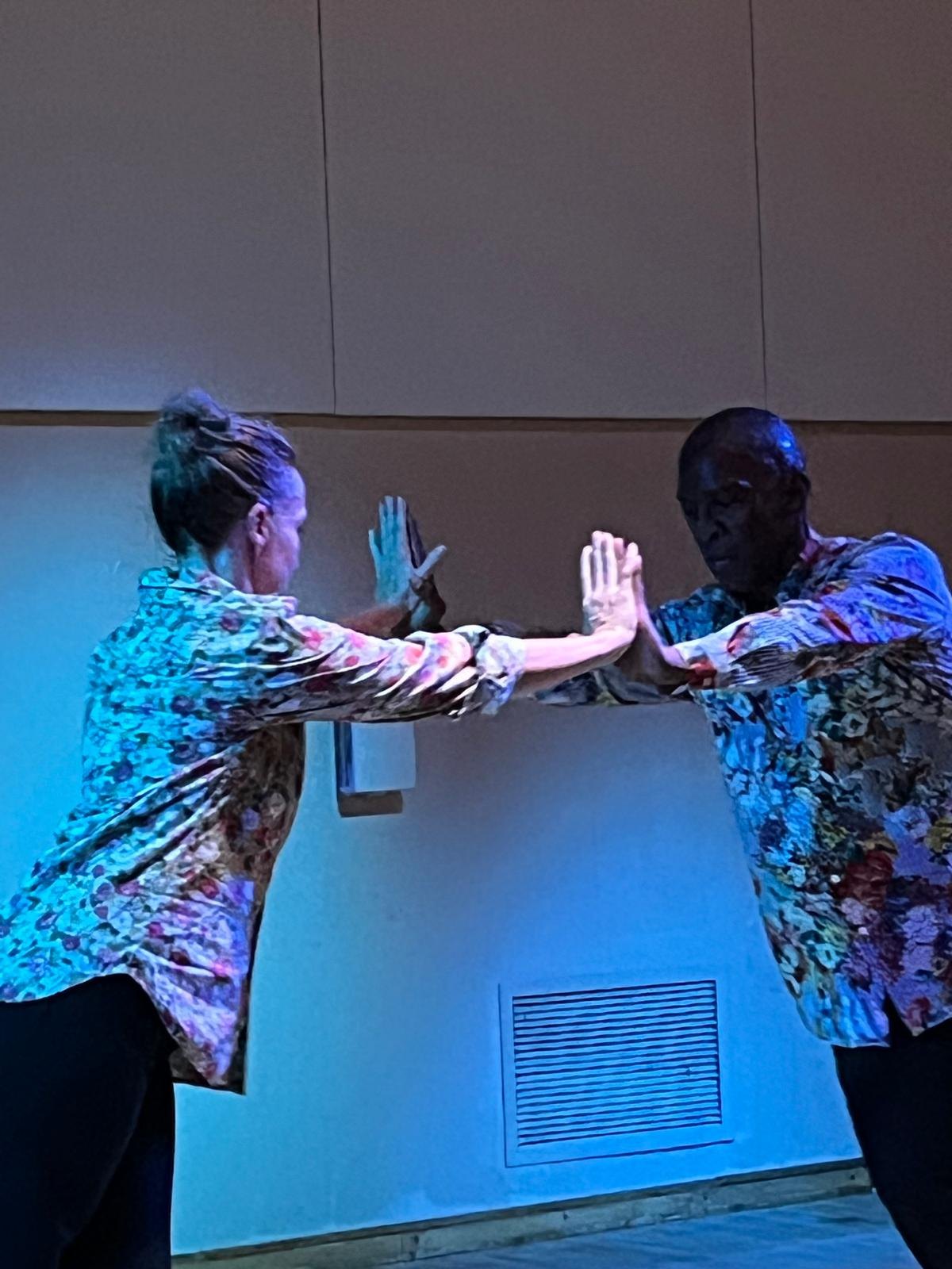 Keira Hart and Boris Willis facing each other with palms pressed together