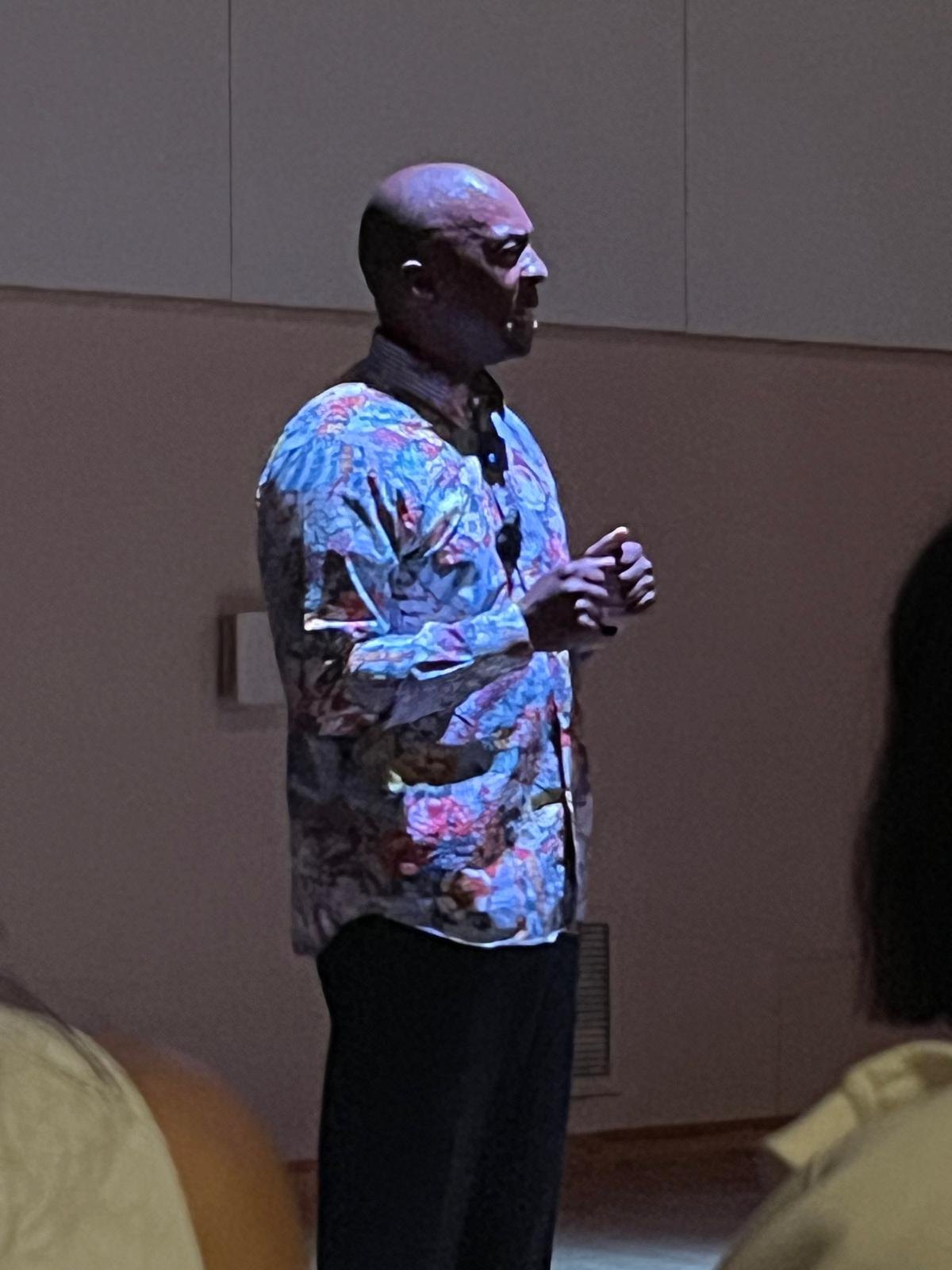 Boris Willis in profile, speaking to the audience