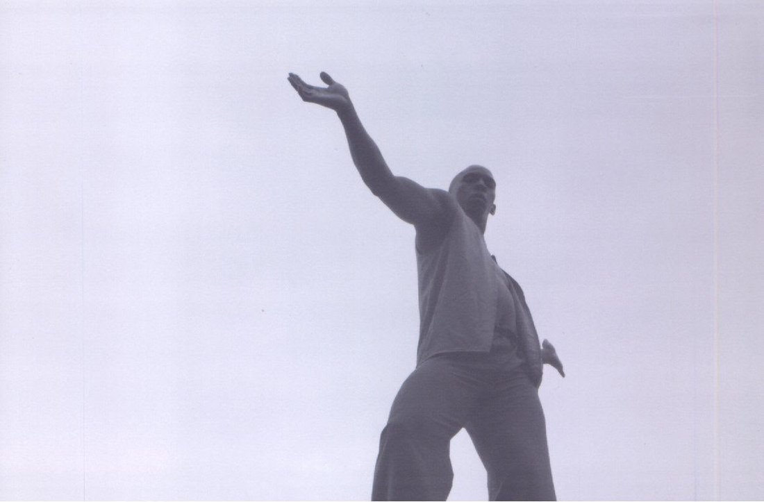 Boris Willis reaching skyward, low angle