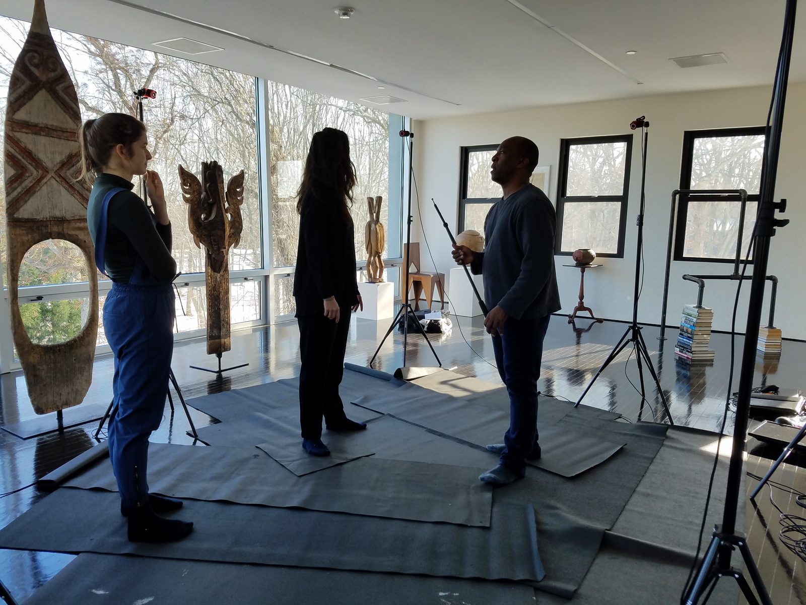 Boris Willis and dancers working with cameras and tripods in a studio surrounded by sculptures